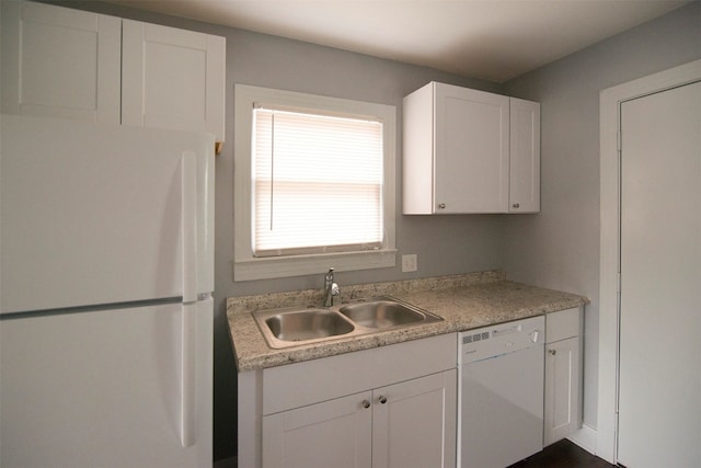 kitchen with white cabinets, white appliances, and sink