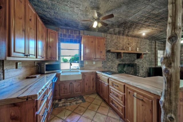 kitchen with ceiling fan, light tile floors, sink, a fireplace, and black electric stovetop