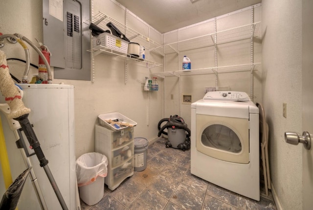 washroom with dark tile flooring, washer / clothes dryer, and water heater