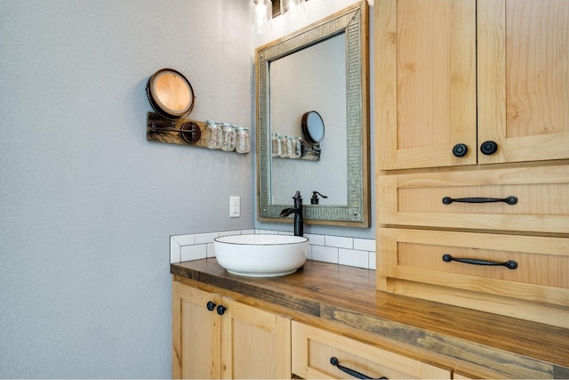 bathroom with vanity and backsplash