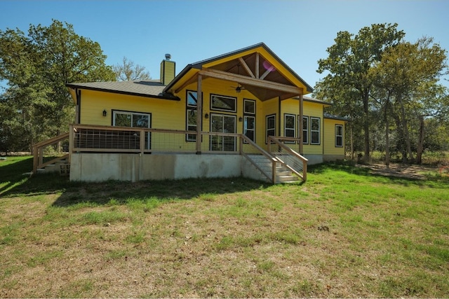 rear view of property featuring a yard