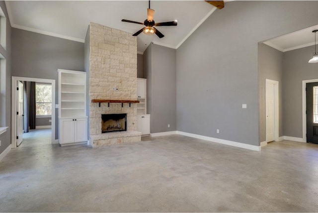 unfurnished living room with high vaulted ceiling, a stone fireplace, crown molding, ceiling fan, and built in shelves