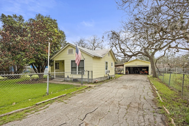 bungalow-style home with a garage, an outdoor structure, and a front yard