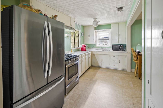 kitchen featuring white cabinetry, sink, and appliances with stainless steel finishes