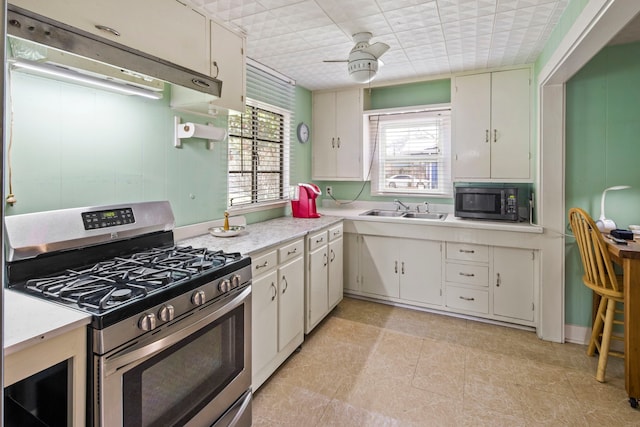 kitchen with white cabinetry, stainless steel appliances, and sink