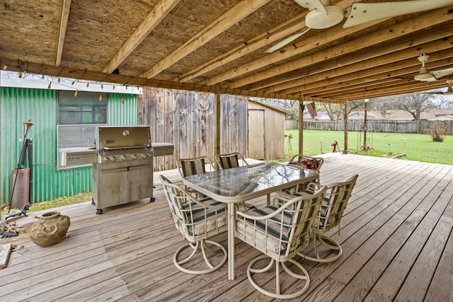 deck featuring a yard and a grill