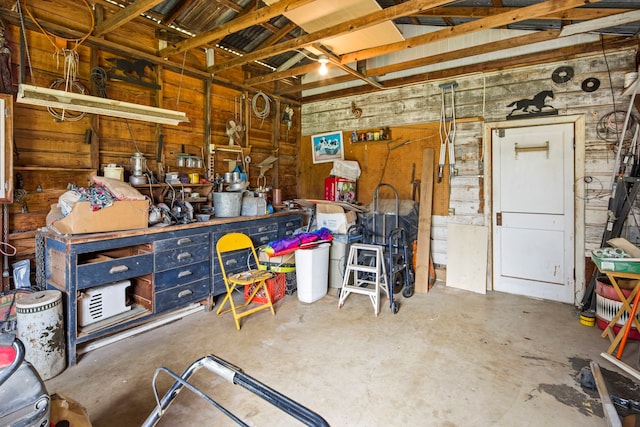 garage featuring a workshop area and wood walls