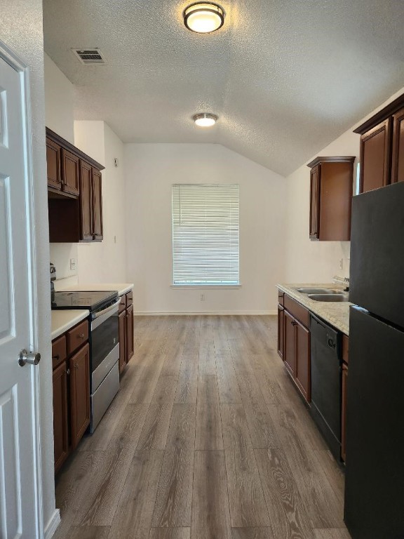 kitchen with electric range, light hardwood / wood-style flooring, refrigerator, dishwasher, and sink