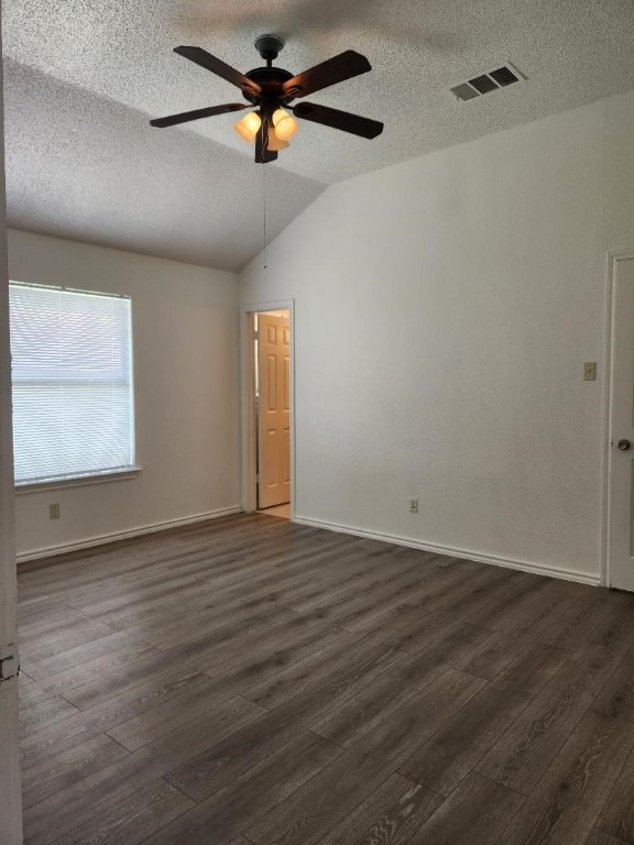 unfurnished room featuring hardwood / wood-style flooring, a textured ceiling, lofted ceiling, and ceiling fan