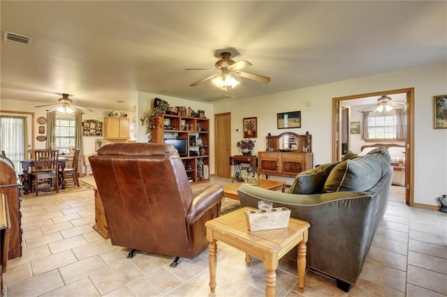 living room with ceiling fan and light tile floors