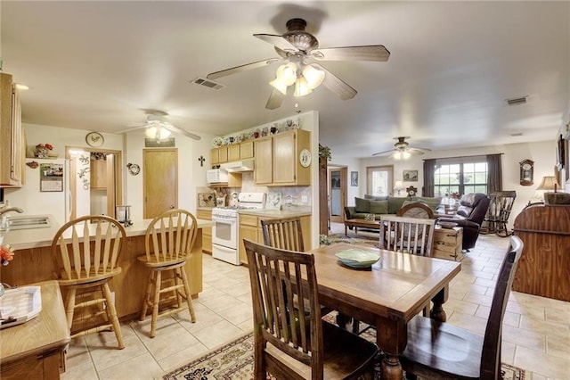 dining room with ceiling fan, sink, and light tile flooring