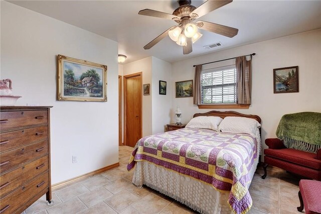 bedroom with ceiling fan and light tile floors