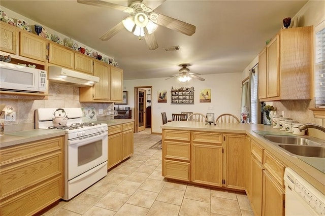 kitchen with ceiling fan, light tile floors, sink, white appliances, and tasteful backsplash