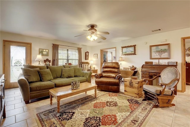 living room with ceiling fan and light tile flooring