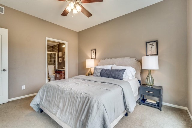 carpeted bedroom featuring ensuite bath and ceiling fan