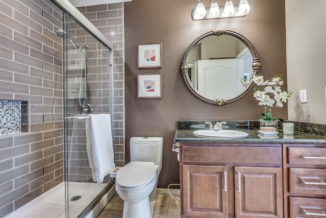 bathroom with walk in shower, vanity, toilet, and tile patterned flooring