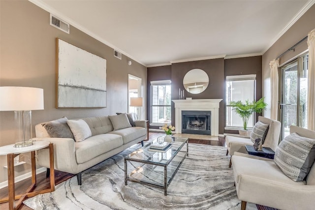 living room featuring wood-type flooring and ornamental molding