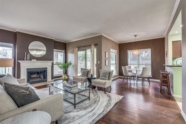 living room with ornamental molding, a chandelier, dark hardwood / wood-style floors, and wooden walls