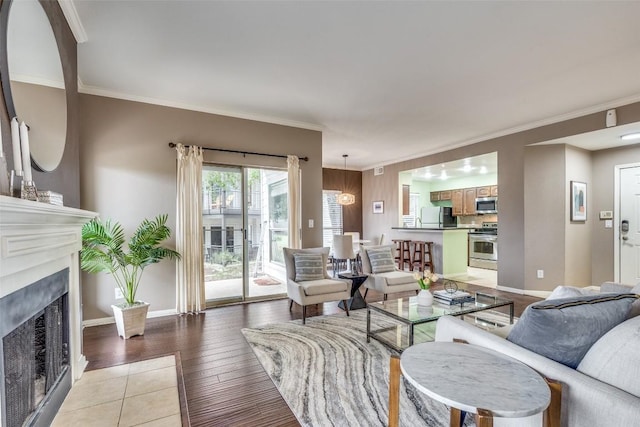 living room featuring crown molding and light hardwood / wood-style floors