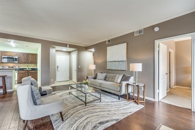 living room featuring hardwood / wood-style flooring and crown molding