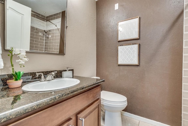 bathroom with tile patterned floors, vanity, toilet, and walk in shower