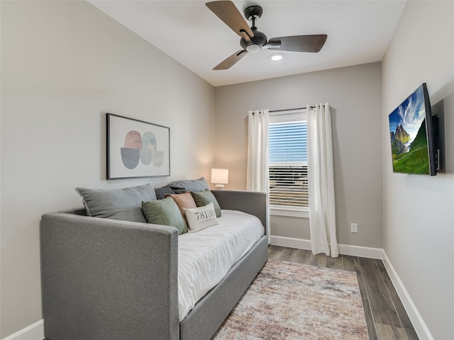 living room featuring ceiling fan and hardwood / wood-style floors