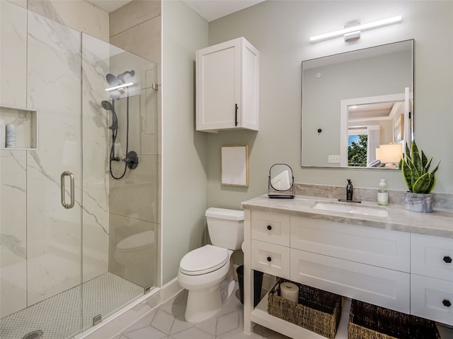 bathroom featuring tile patterned floors, a shower with door, vanity, and toilet