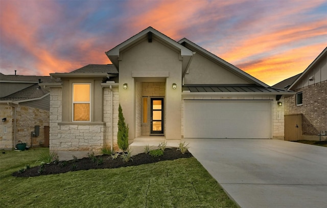 view of front of house with a yard and a garage