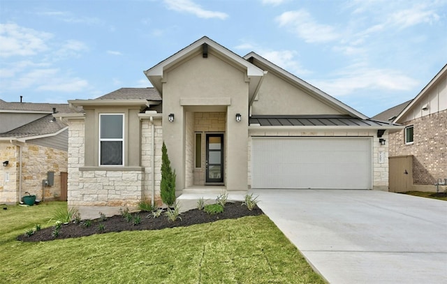 view of front of property featuring a garage and a front lawn