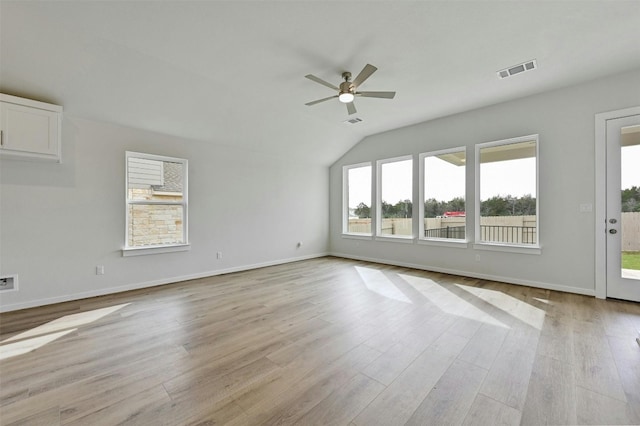 unfurnished room with lofted ceiling, light hardwood / wood-style floors, and ceiling fan