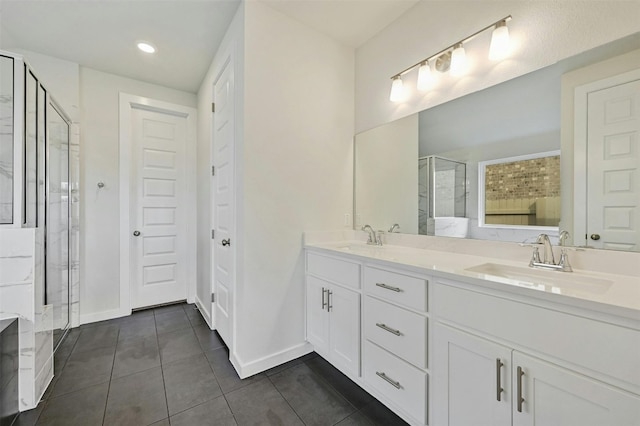 bathroom with dual sinks, tile floors, walk in shower, and large vanity