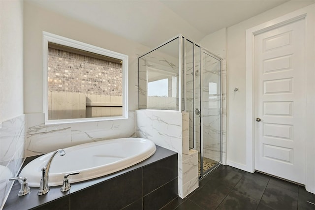 bathroom with tile flooring and separate shower and tub