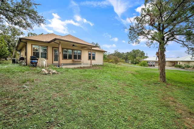 rear view of house with a lawn