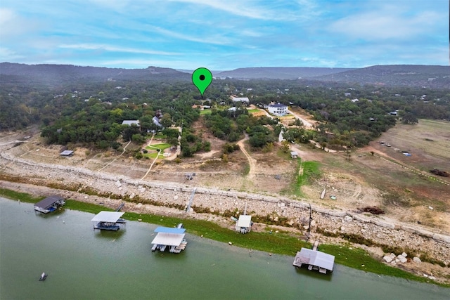 bird's eye view with a water and mountain view