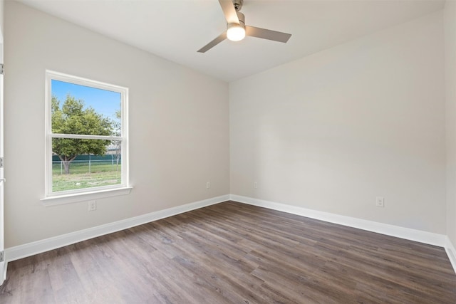 spare room featuring dark hardwood / wood-style flooring and ceiling fan