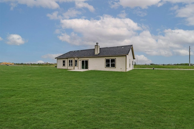 back of property with a patio area and a yard