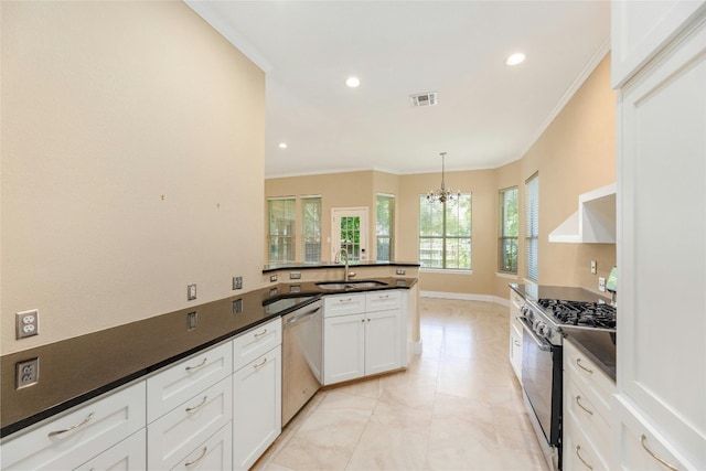 kitchen with pendant lighting, white cabinets, sink, a notable chandelier, and stainless steel appliances