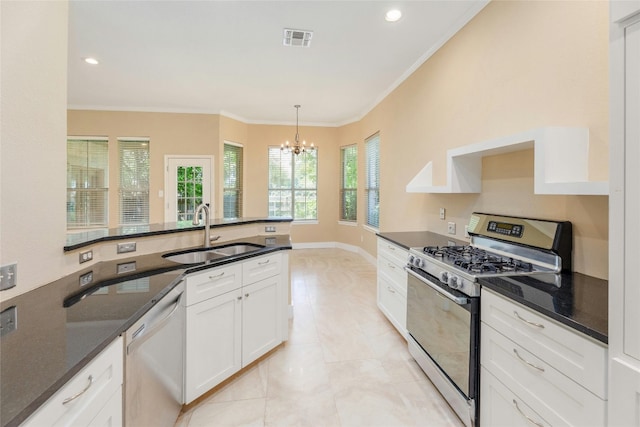 kitchen featuring white cabinetry, sink, stainless steel appliances, a chandelier, and decorative light fixtures