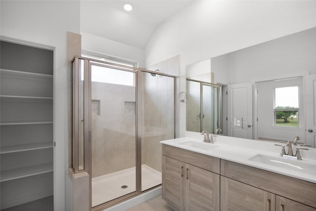 bathroom with vanity, an enclosed shower, and vaulted ceiling