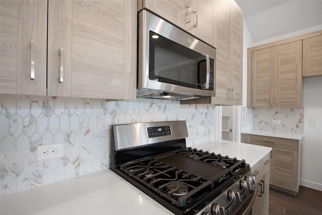 kitchen featuring decorative backsplash, dark hardwood / wood-style flooring, stainless steel appliances, and light brown cabinetry