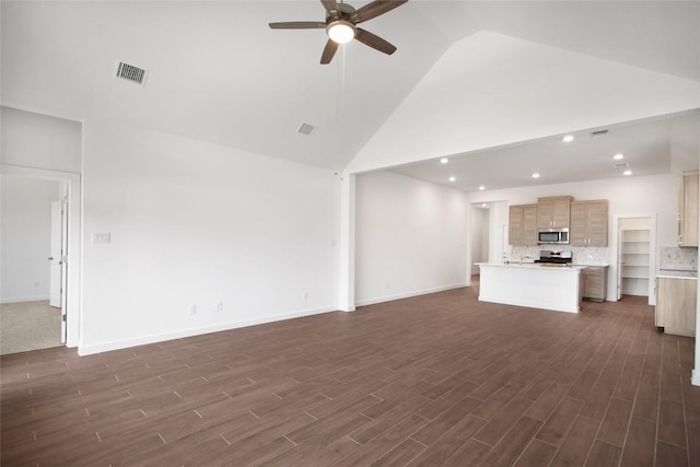 unfurnished living room with ceiling fan and high vaulted ceiling