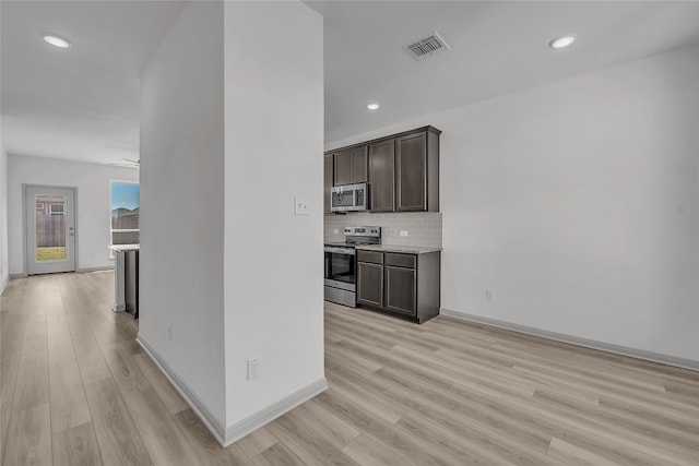 kitchen featuring ceiling fan, stainless steel appliances, dark brown cabinets, and light hardwood / wood-style flooring