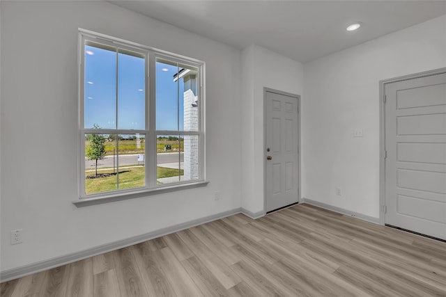 unfurnished room with light hardwood / wood-style floors and a healthy amount of sunlight