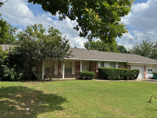 ranch-style house with covered porch, a garage, and a front lawn