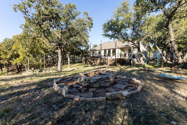 view of yard with an outdoor fire pit and a wooden deck