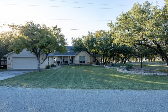 ranch-style house featuring a front lawn and a garage