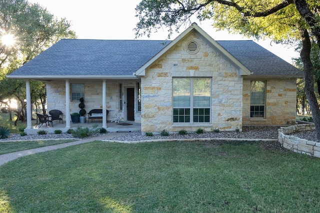 view of front facade with a front yard and a patio