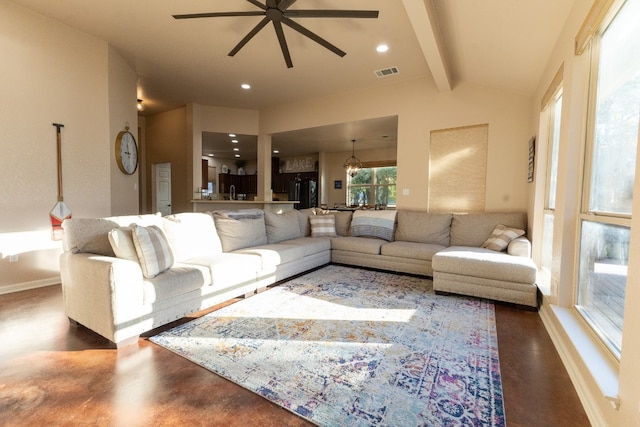 living room featuring vaulted ceiling with beams and ceiling fan with notable chandelier