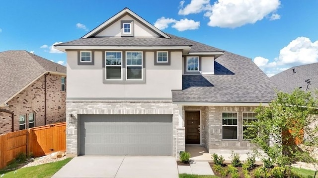 view of front of property with fence, an attached garage, stucco siding, concrete driveway, and brick siding