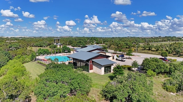 drone / aerial view with a wooded view